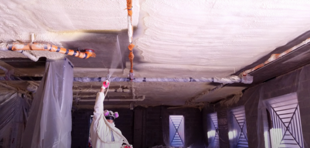 spray foam insulation being applied to a ceiling with a spray foam gun