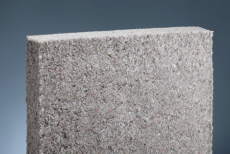 A grey square block of cellulose insulation